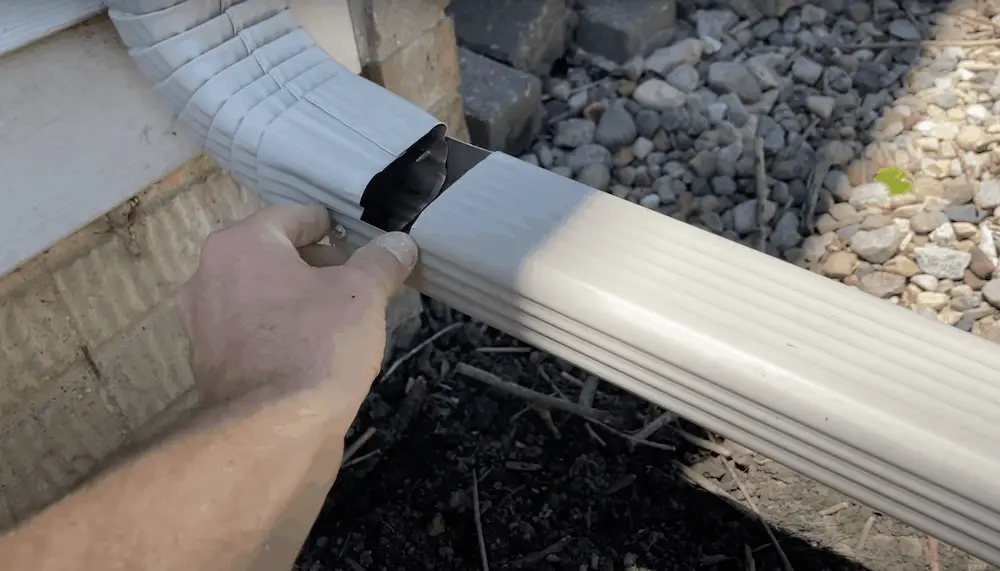 cutting out downspout extension to allow storage in the up position