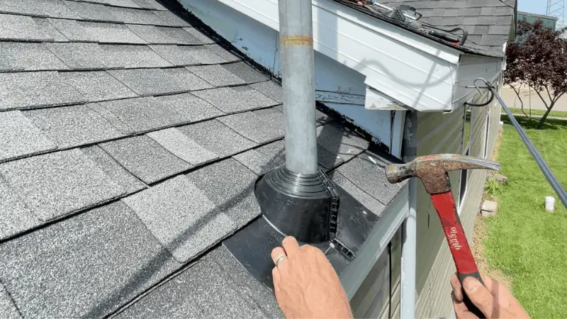 securing bottom edge of roof boot with 4 nails