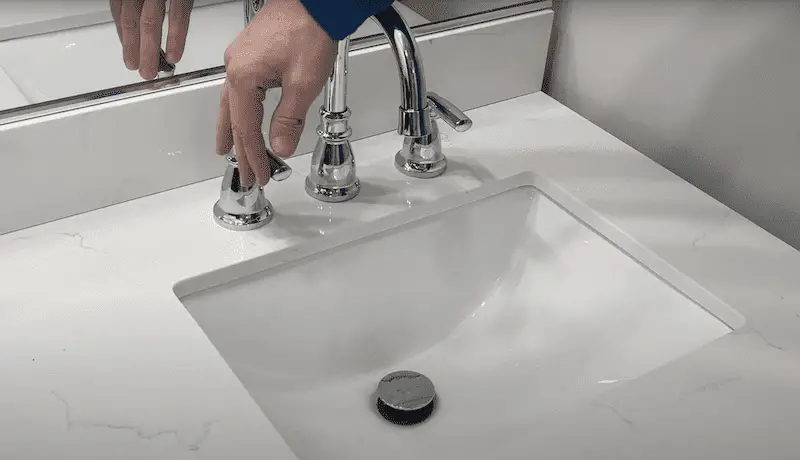 Turning on both sides of a faucet to get remaining water out