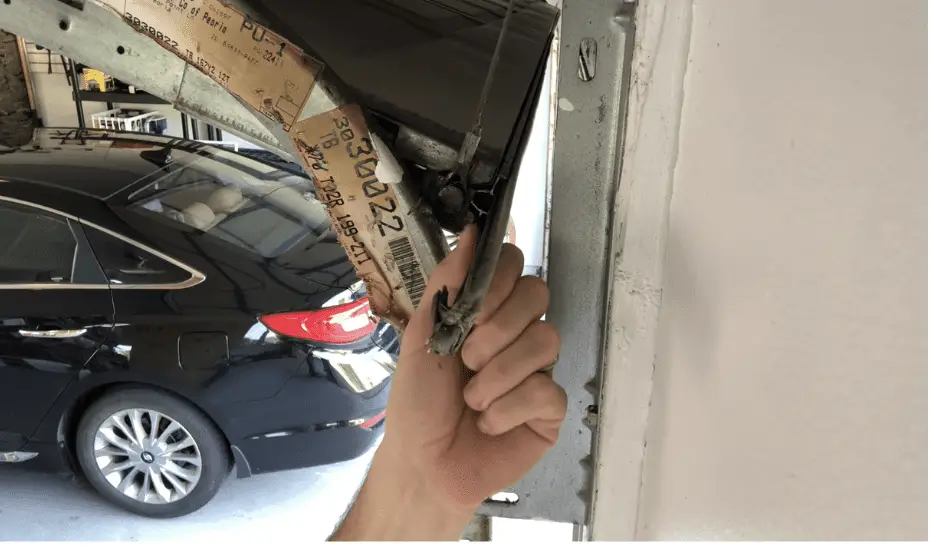 exposing the old garage door bottom seal