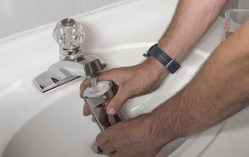 Flushing out the tub spout with water