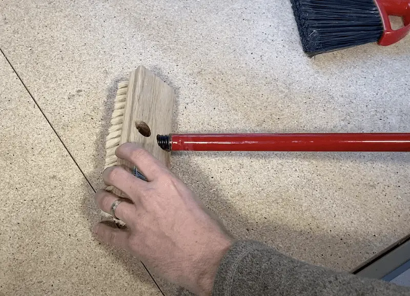 Attaching a broomstick to a bristle brush