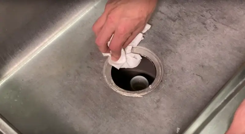 Replace a Kitchen Sink Strainer: cleaning old putty or silicone off the surface of the sink after removing the old strainer