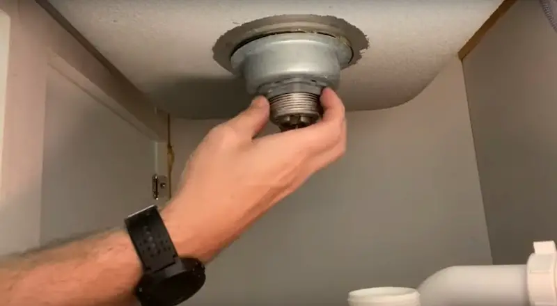 Replace a Kitchen Sink Strainer: loosening the locknut
