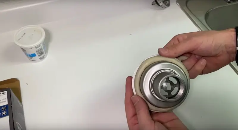 Replace a Kitchen Sink Strainer: applying the rolled out putty to the underside of the strainer