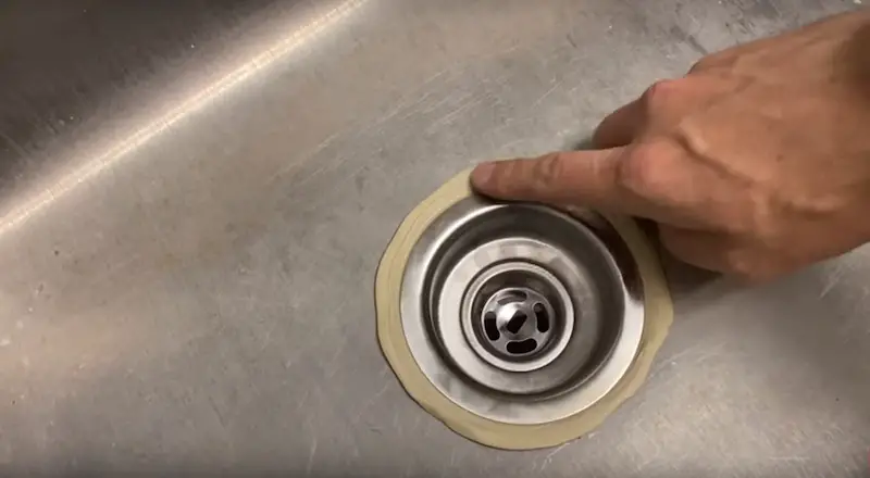 Replace a Kitchen Sink Strainer: checking the putty after the new strainer has been tightened into place