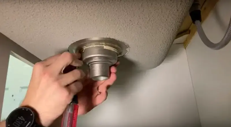 Replace a Kitchen Sink Strainer: removing excess putty on the underside of the sink