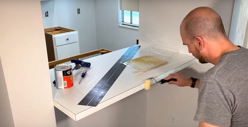 Applying contact cement to sides of countertop