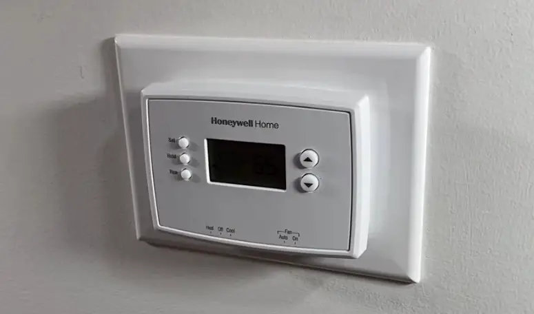 A base plate can be made out of a switch cover plate to account for the smaller size of the new thermostat.