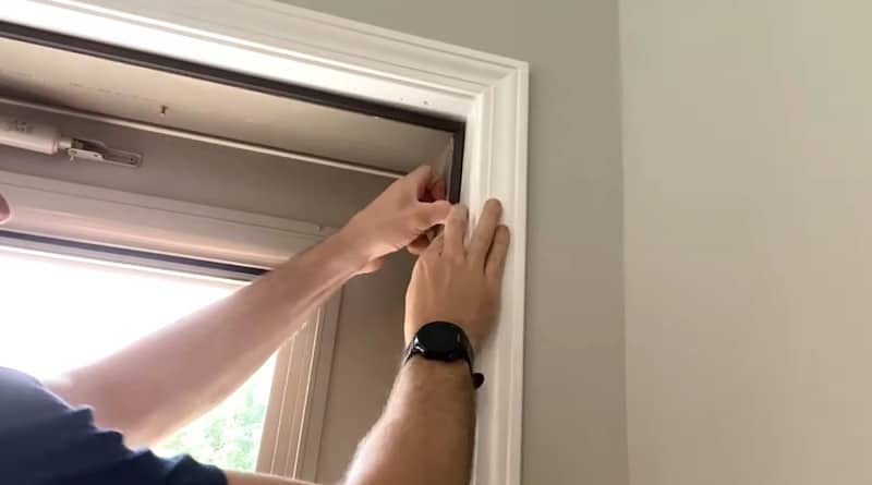 The doorknob side weather-stripping is measured, cut, and fitted into place similar to the top piece.