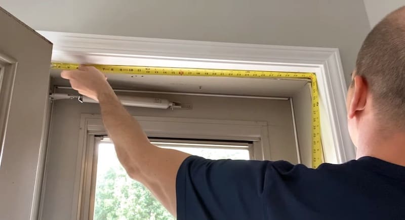 Take an accurate measurement of the top of the door (jamb to jamb)