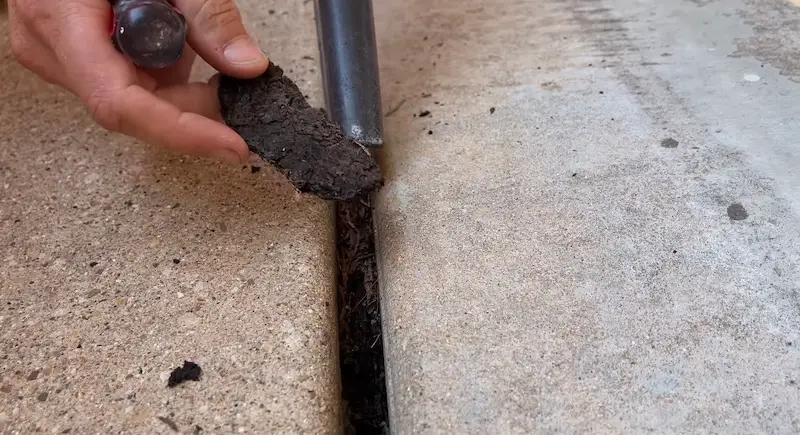 Removing the remnants of the original fiber expansion joint material