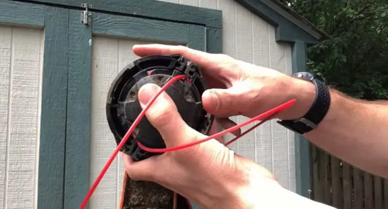 Lining up the notch of the spool with the slot in the trimmer head casing