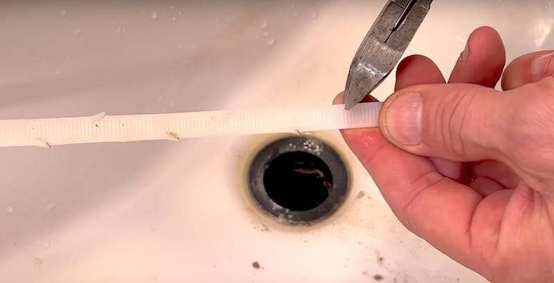 Making the drain snake by snipping a long piece of zip tie