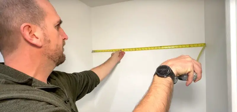 Measuring the width of the back wall of the closet