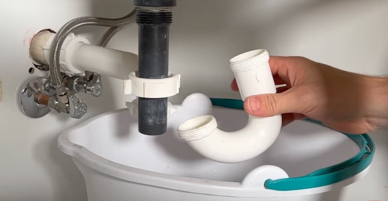 How To Unclog A Bathroom Sink Drain: Reinstalling the P-trap (longer end attaches to tailpipe)