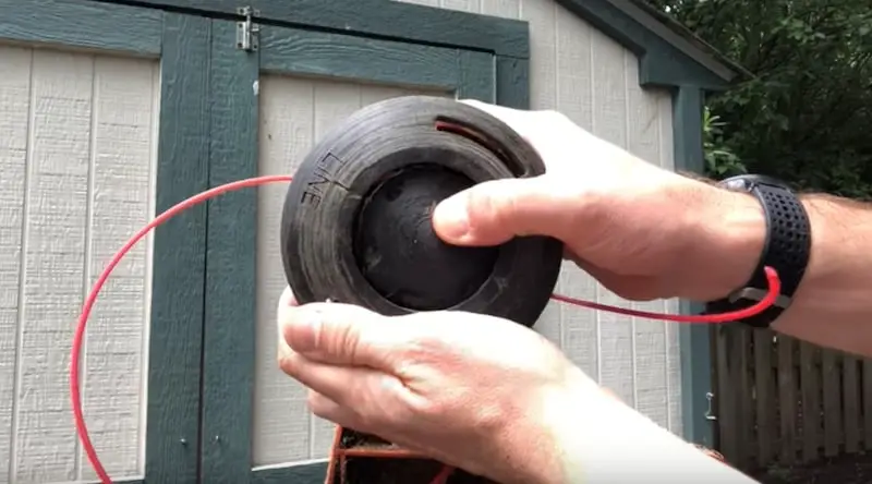 Remounting the cover: manipulating it into place, keeping pressure on the spool