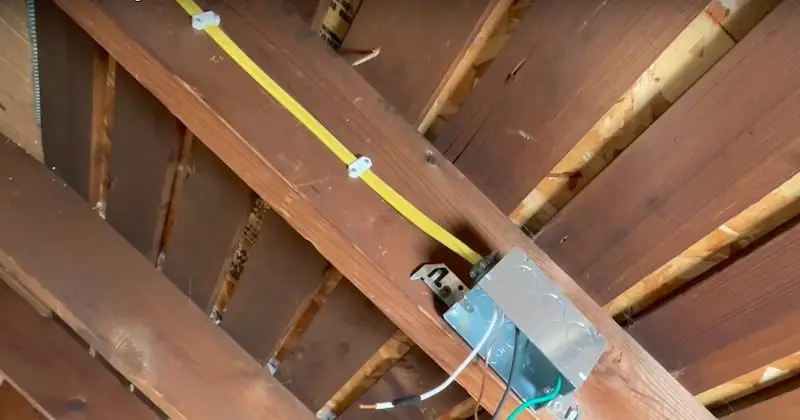 Romex from switch secured with clips in the middle of the rafter