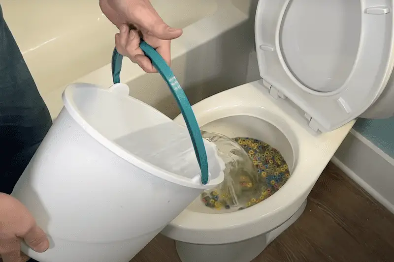 Flushing the water down the toilet manually