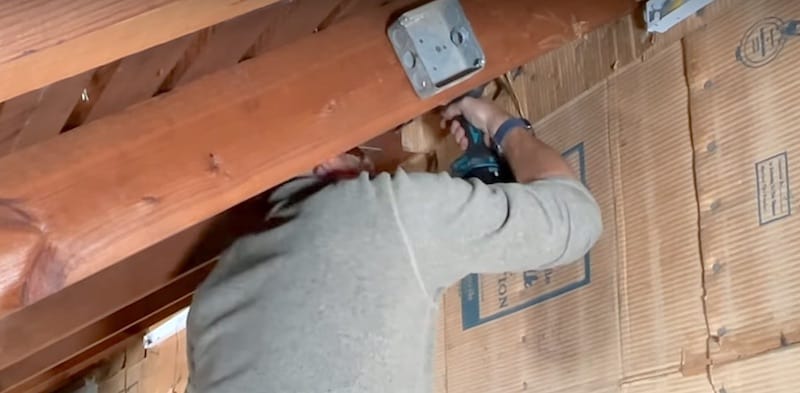 Drilling holes in the rafters