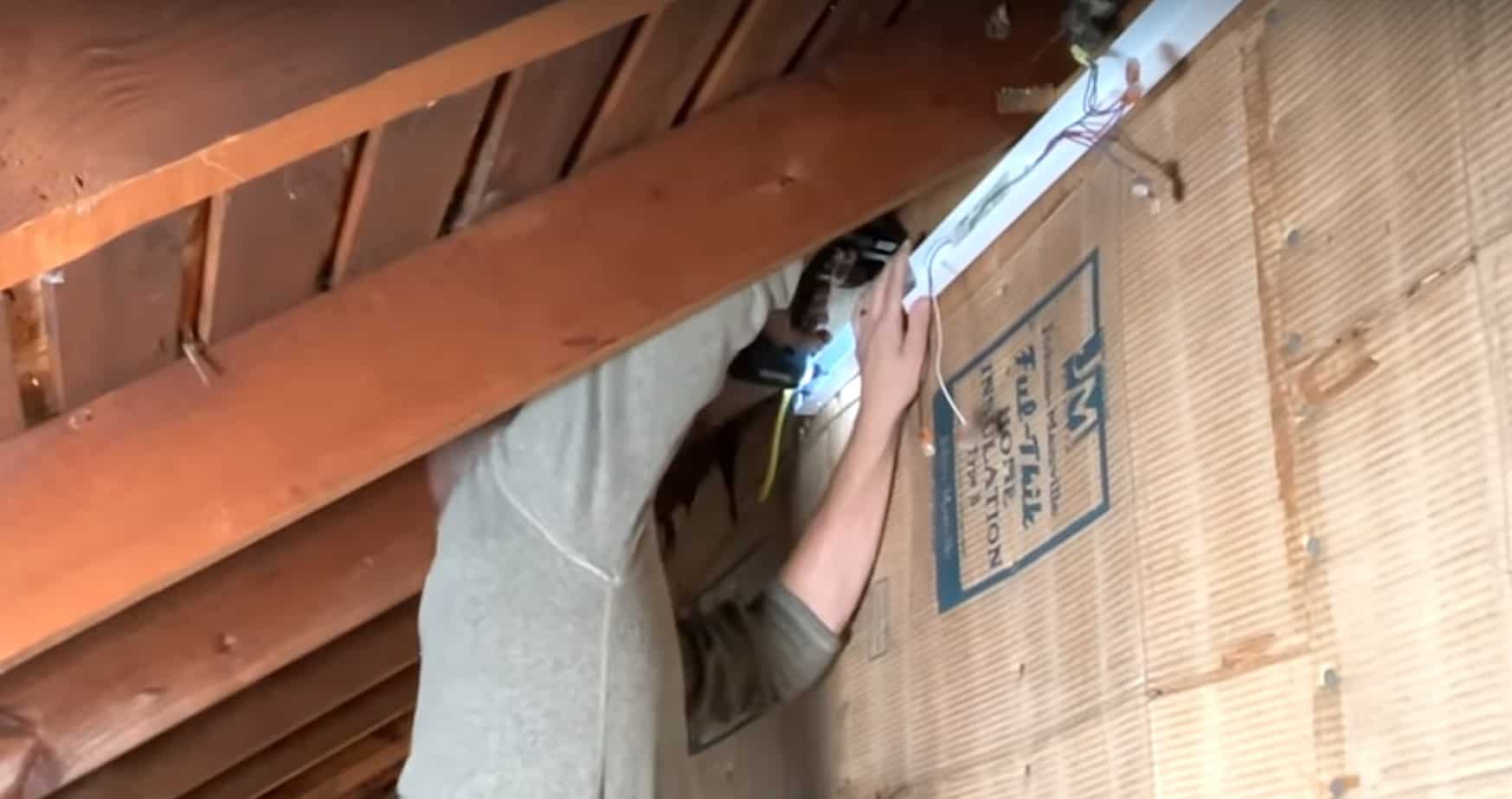 Mounting the housing of the first light fixture to studs