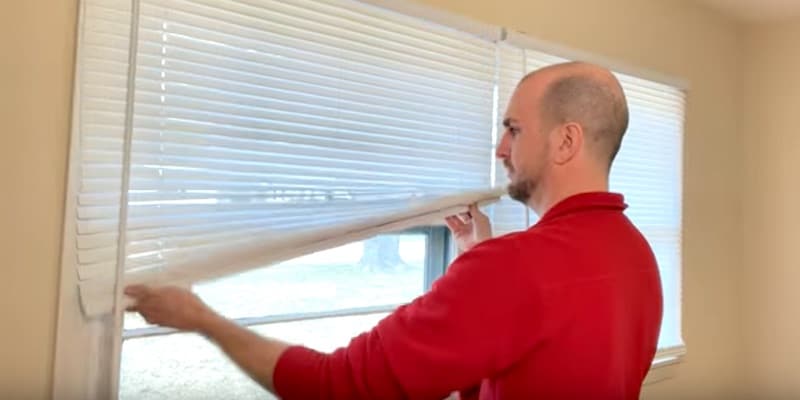 How to Fix Crooked Cordless Window Blinds: Pulling down aggressively on the blind using a teeter-totter motion
