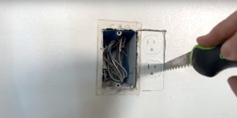How to Double a Duplex Receptacle: Using a jab saw to cut the drywall