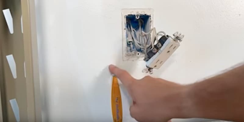 Magnetic stud finder locates drywall screws, indicating stud