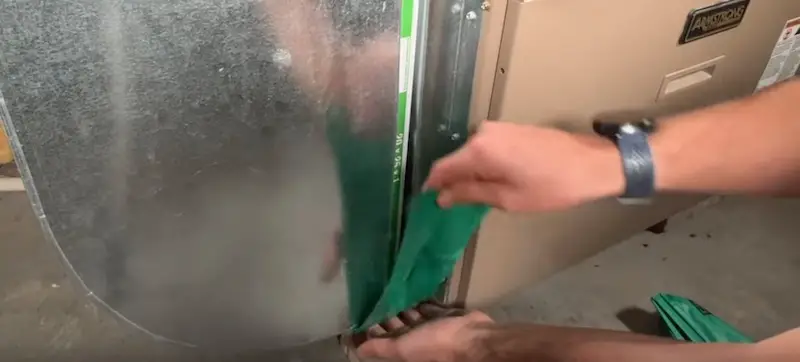 Easy Fix for an Open Furnace Filter Slot: Applying the bottom piece of the magnetic seal