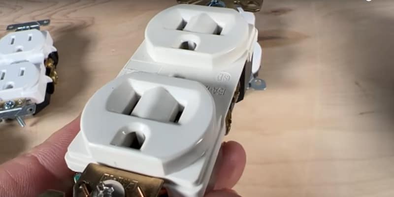 Slopes around the outlet slots make it easier to insert a plug in low-light or hard-to-reach places