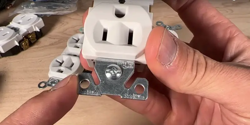 The curved channels serve as built-in wire strippers on a spec-grade outlet