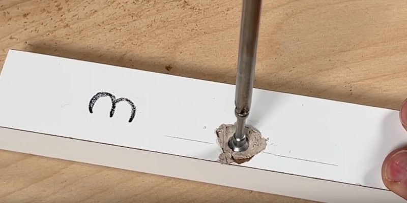 Fix Damaged Ikea Furniture: Carefully threading the cam screw into place through the Kwikwood