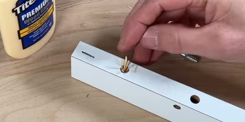 Fix Damaged Ikea Furniture: Lining the hole with toothpick shavings