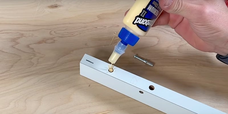 Fix Damaged Ikea Furniture: Adding a couple of drops of wood glue to the shavings