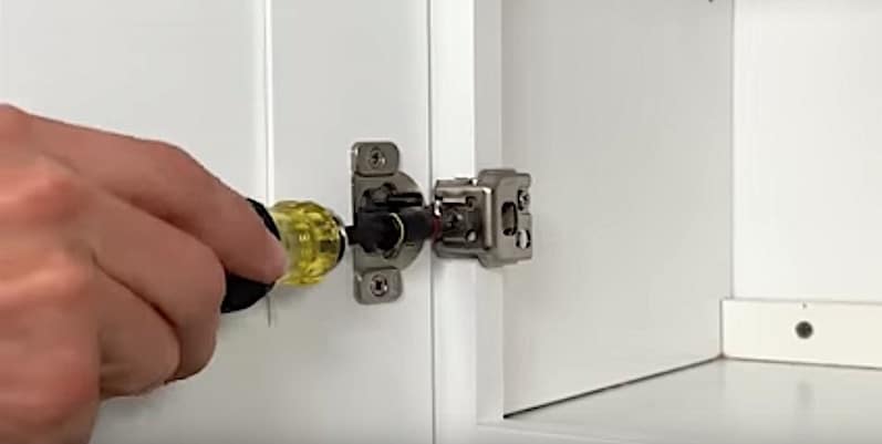 How to Realign Cabinet Doors: The front screw of a compact concealed hinge adjusts the lateral positioning