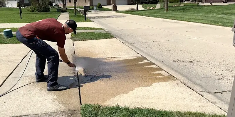 Flushing soil out of the crack with a hose