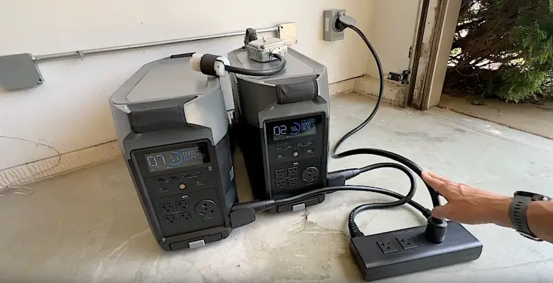 The test setup: Two EcoFlow Delta Pro portable power units linked by a dual-voltage hub