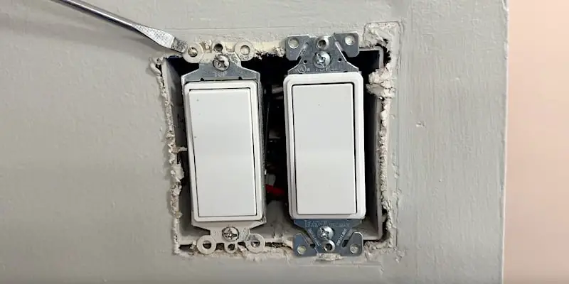 Ears of two Decora light switches sitting directly on drywall