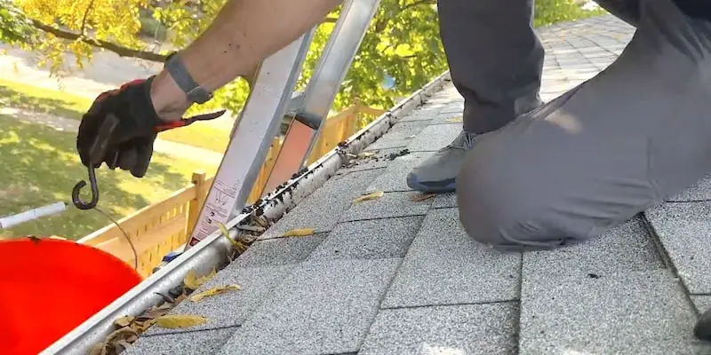 How to Select and Install Gutter Guards: Hanging a bucket on the edge of the gutter makes the work easy and reduces mess