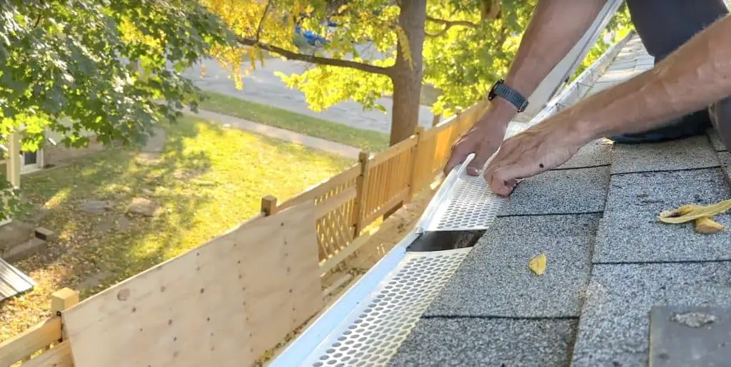 Installing perforated plastic gutter guards is a snap