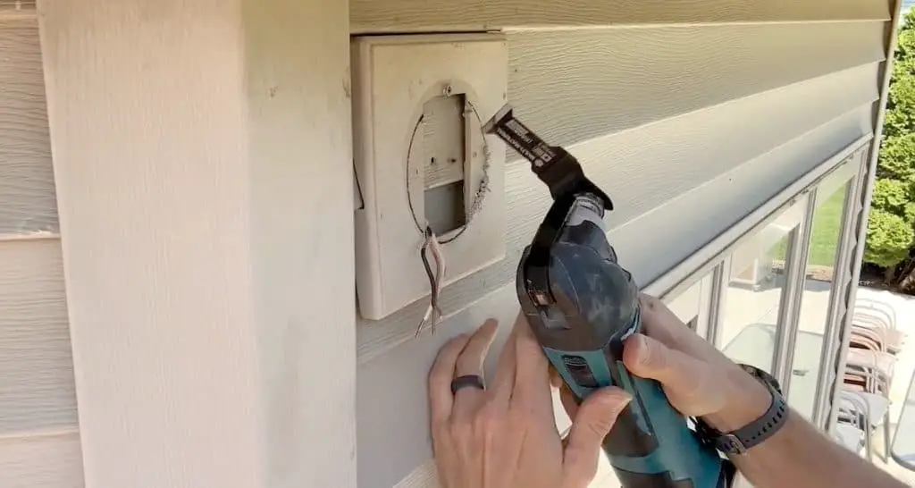 How to Install an Exterior Light: Cutting a hole for the pancake box with an oscillating tool