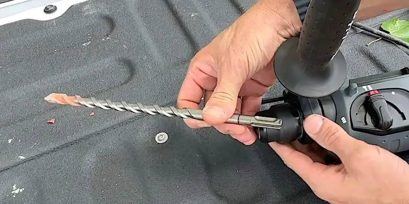 The drill bit for a rotary hammer drill has an SDS Plus design